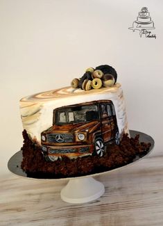 a cake decorated with an image of a truck and logs on top is sitting on a plate