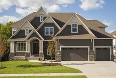 a large house with two garages in the front yard