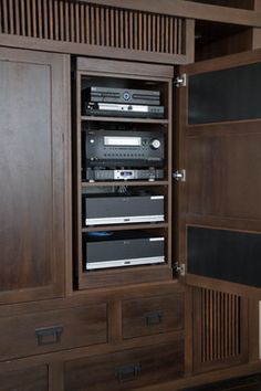 an entertainment center with many different types of audio equipment in the cabinet and on shelves