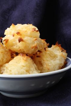 a white bowl filled with food on top of a blue cloth