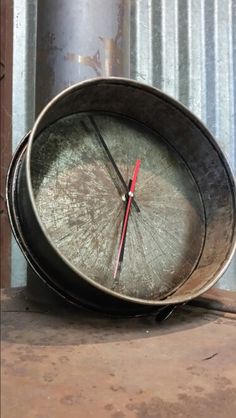 an old metal clock sitting on top of a table