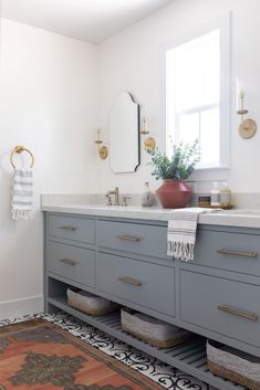 a bathroom with two sinks and a rug on the floor