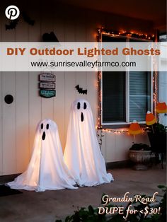 two white ghost statues sitting in front of a house with the words diy outdoor lighted ghosts