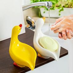 a person washing their hands with soap and water from a faucet in a sink