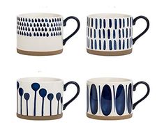 four coffee mugs with blue and white designs on them