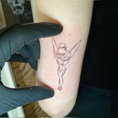 a person with a small tattoo on their foot holding onto the arm of another person