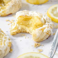 lemon filled pastries with icing and sliced lemons