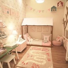 a child's bedroom decorated in pink and white