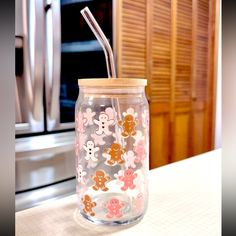 a glass jar with a straw in it sitting on a counter