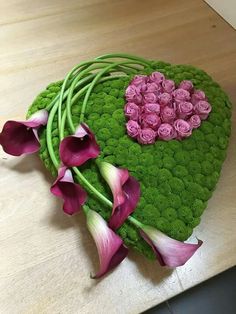 a green heart shaped box with pink flowers on it