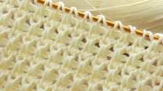 closeup of the crochet stitchs on a white blanket