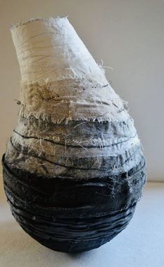 a black and white vase sitting on top of a table