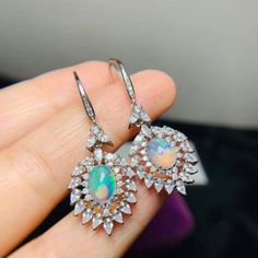 Welcome to Elegant Art Jewelry!  Material: 925 Sterling Silver Stone: Natural Opal Stone Size: 6mmX8mm Side Stone: Zircon Stone Cut: Cabution Oval Plated: Rose Gold Personalization: 9K/14K/24K/GOLD/SILVER/PLATINUM/ROSE-GOLD/WHITE GOLD. (Contact me)  Opal Earrings, Opal Cuff Earrings, Gold Earrings, Gold Stud Earrings, 14k Gold Earrings, 14k Gold Earrings, Round Cut Earrings, Round Cut Stone Earrings, Round Cut Studs Earrings, Opal Drop Earrings, Opal Studs Earrings, Opal Studs, Opal Earrings, Op Silver Oval Cluster Earrings In Sterling Silver, Oval Silver Cluster Earrings In Sterling Silver, Sterling Silver Dangle Earrings With Halo Design, Oval Sterling Silver Cluster Earrings, Dangle Earrings With Halo Design For Gift, Sterling Silver Halo Design Dangle Earrings, Sterling Silver Halo Earrings For Party, Halo Design Dangle Earrings As Gift, Halo Design Dangle Earrings For Gifts