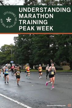 people running in a marathon on the road with a sign that reads, under standing marathon training peak week