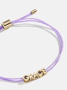 Our best-selling Custom Cord bracelet adds the prettiest pop of subtle color to any bracelet stack. Miniature gold letters are strung on a comfortable pull-tie cord. Select up to 12 characters, see our Letter Key for details. Beads are designed to slide and move with you, offering comfort and flexibility. String Bracelets, Neon Purple, Cord Bracelet, Metallic Pink, String Bracelet, Metallic Blue, Cord Bracelets, Gold Letters, Neon Blue