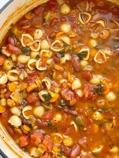 a pot filled with pasta and vegetables on top of a stove