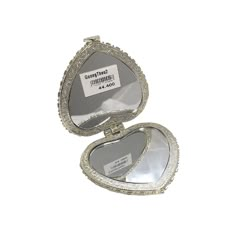 an empty silver heart shaped box on a white background