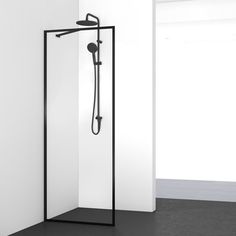 an open shower in a white room with black accents