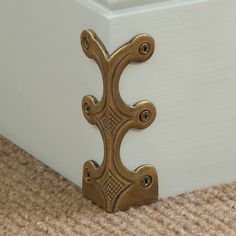 a close up of a door handle on a carpeted floor near a white box