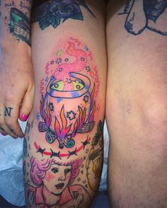 two women's legs with tattoos on them