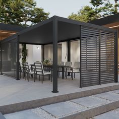 an outdoor dining area with table and chairs on concrete steps leading up to a covered patio