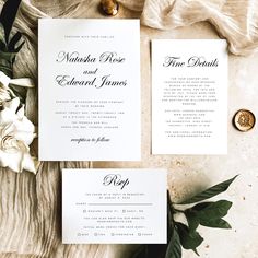 the wedding stationery is laid out on top of a table with flowers and greenery