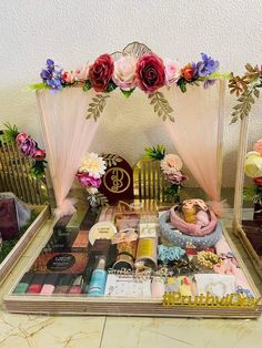 a table topped with lots of different types of items and flowers on top of it