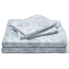 two sheets that are folded on top of each other in blue and white floral print