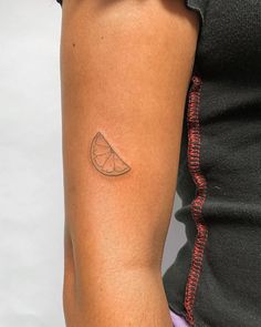 a woman with a small tattoo on her arm