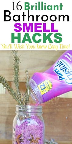 a jar filled with purple sand next to a bottle of bathroom and some plants