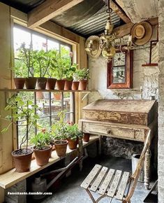 an old wooden table with potted plants on it in front of a window sill