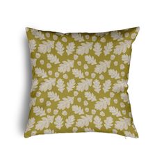 a green pillow with white leaves on it