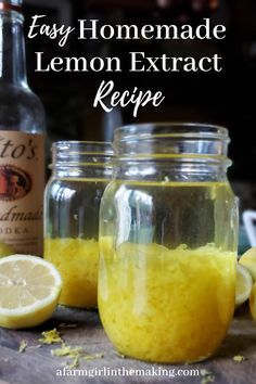 two mason jars filled with lemons sitting on top of a table next to bottles