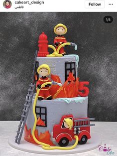 a cake with fire fighters on it and flames coming out of the top, as well as ladders