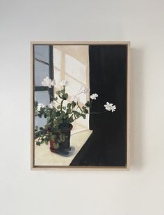 a painting hanging on the wall next to a vase with flowers in it and an open window