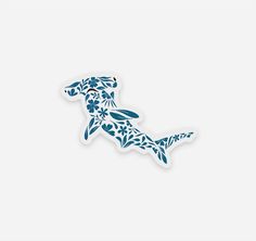 a sticker with the shape of a dog in blue and white flowers on it