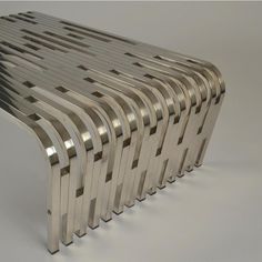 a set of six stainless steel benches sitting on top of a white floor next to each other