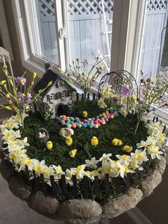 a birdhouse is decorated with flowers and eggs