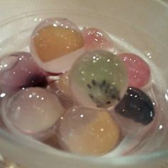 several different colored candies in a glass bowl