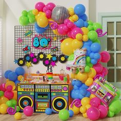 an assortment of balloons and party items on the floor in front of a boombox