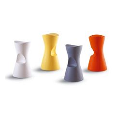 four different colored vases sitting next to each other