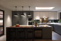 a modern kitchen with an island and bar stools