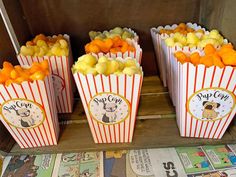 small popcorn bags filled with oranges and apples