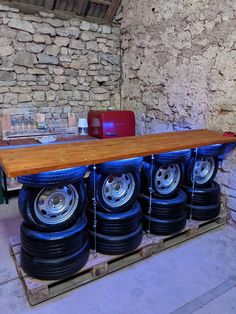 several tires stacked on top of each other in a room with stone walls and flooring