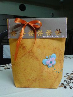 a paper bag with a bow on it sitting on a table