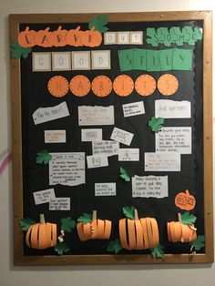 a bulletin board with pumpkins and writing on it