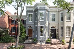 this is an image of a large house in the suburbs with many trees and bushes