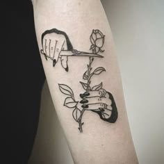 a woman's arm with two hands holding a rose and another hand holding a knife