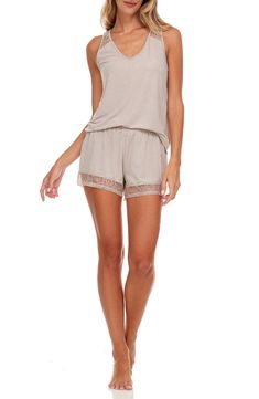 Ethereal lace trims a lightweight tank and shorts pajama set that brings feminine style and instant comfort to your evening. 2-piece set Top: 25" length; Shorts: 10" rise, 3" inseam (size S) Top: V-neck, sleeveless, back lace panel, solid color, knit construction Shorts: elasticized waist, pull-on style, solid color, nit construction, lace trim 62% polyester, 33% rayon, 5% spandex Machine wash cold Imported Model’s stats for sizing: 5’11” height, 32” bust, 24” waist, 34” hips. Model is wearing s Flora Nikrooz, Shorts Pajama Set, Lace Trims, Lace Panelled, Short Pajama Set, Pajama Shorts, Feminine Style, 2 Piece, Pajama Set