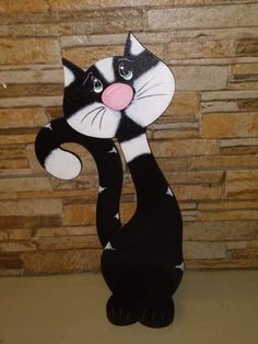 a black and white cat standing on its hind legs